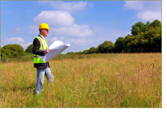 "Image depicts a man surveying land in an open field"